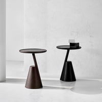 Black brown side tables on a white floor with a light gray wall background