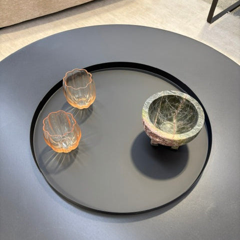 Roxy tray in black on a table holding orange glass bowls and a marble bowl