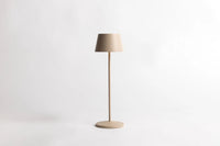 Serene cordless table lamp in sand with a slim stem and round base, on a white background