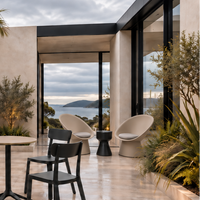 KO stool in black on a terrace with outdoor chairs and a sea view